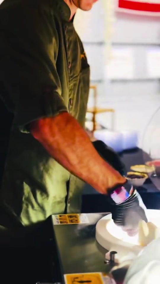 A Two Guys chef serving gelato at Elite Jets Hangar