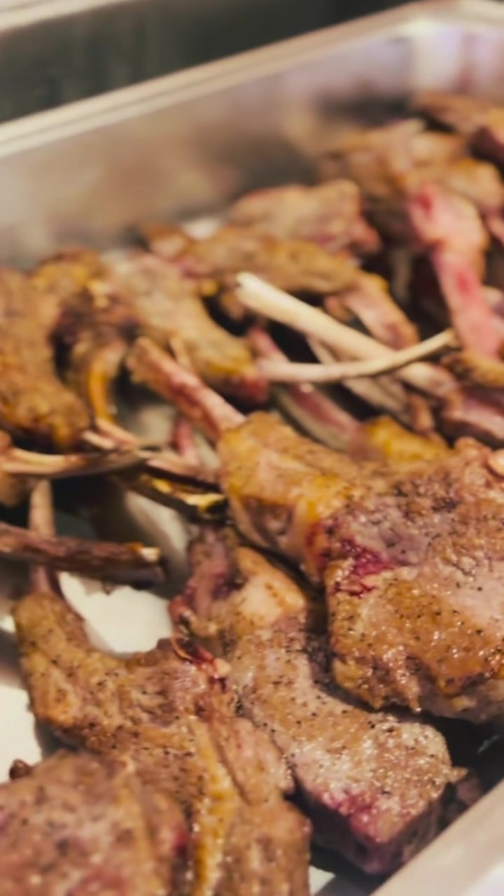 Herb-and-garlic lamb chops arranged for the wedding dinner