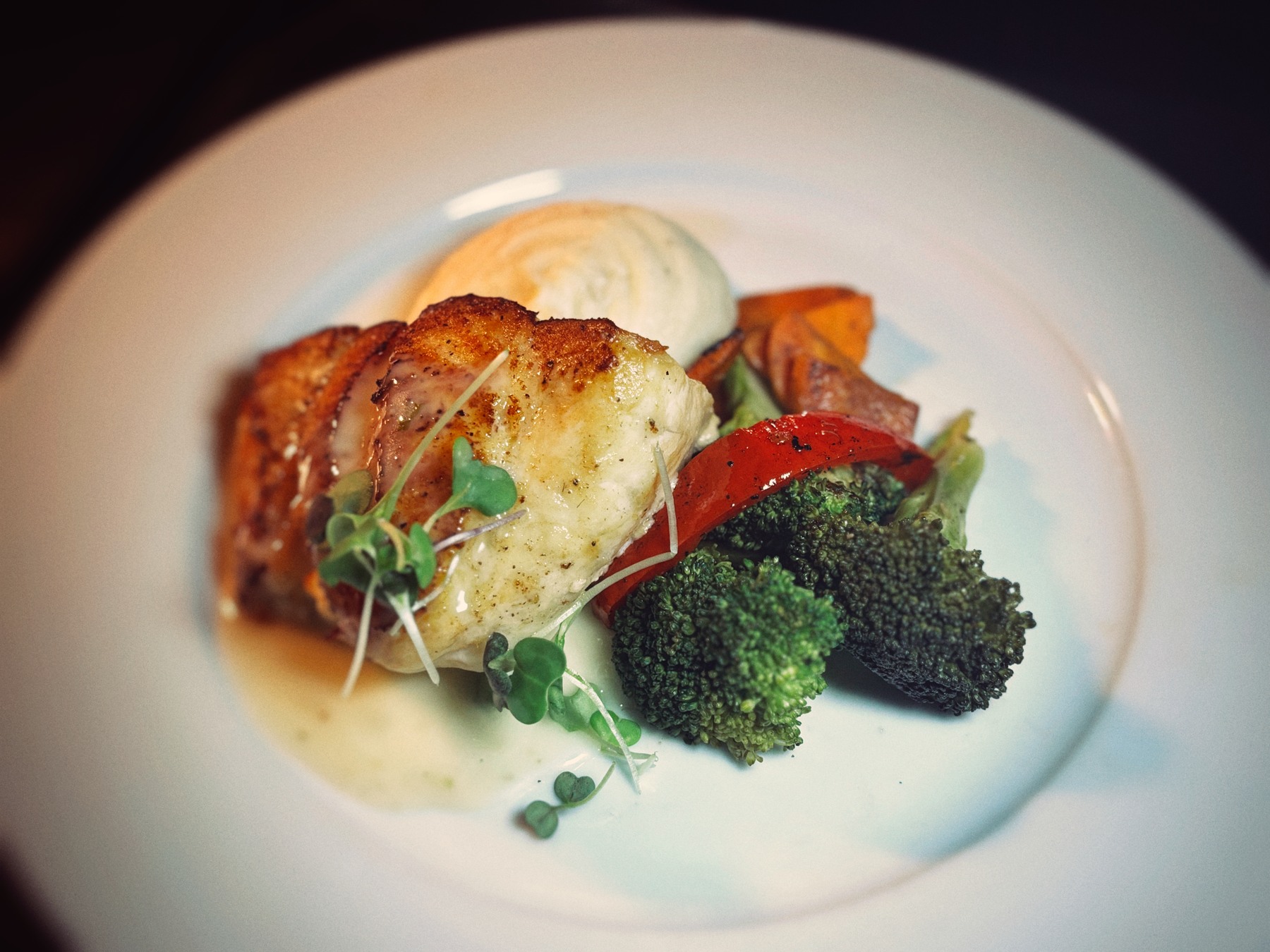 Gulf grouper plated with whipped potatoes, broccoli, and roasted vegetables